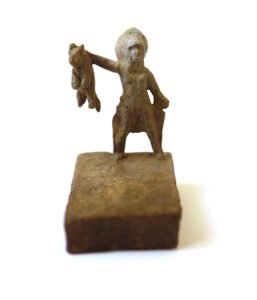 Bronze artwork by Andrew Miguel Fuller. Man presents cat, an absurd cowboy sculpture by AM Andy Fuller