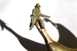 Bronze artwork by Andrew Miguel Fuller. See-saw, an absurd cowboy sculpture by AM Andy Fuller